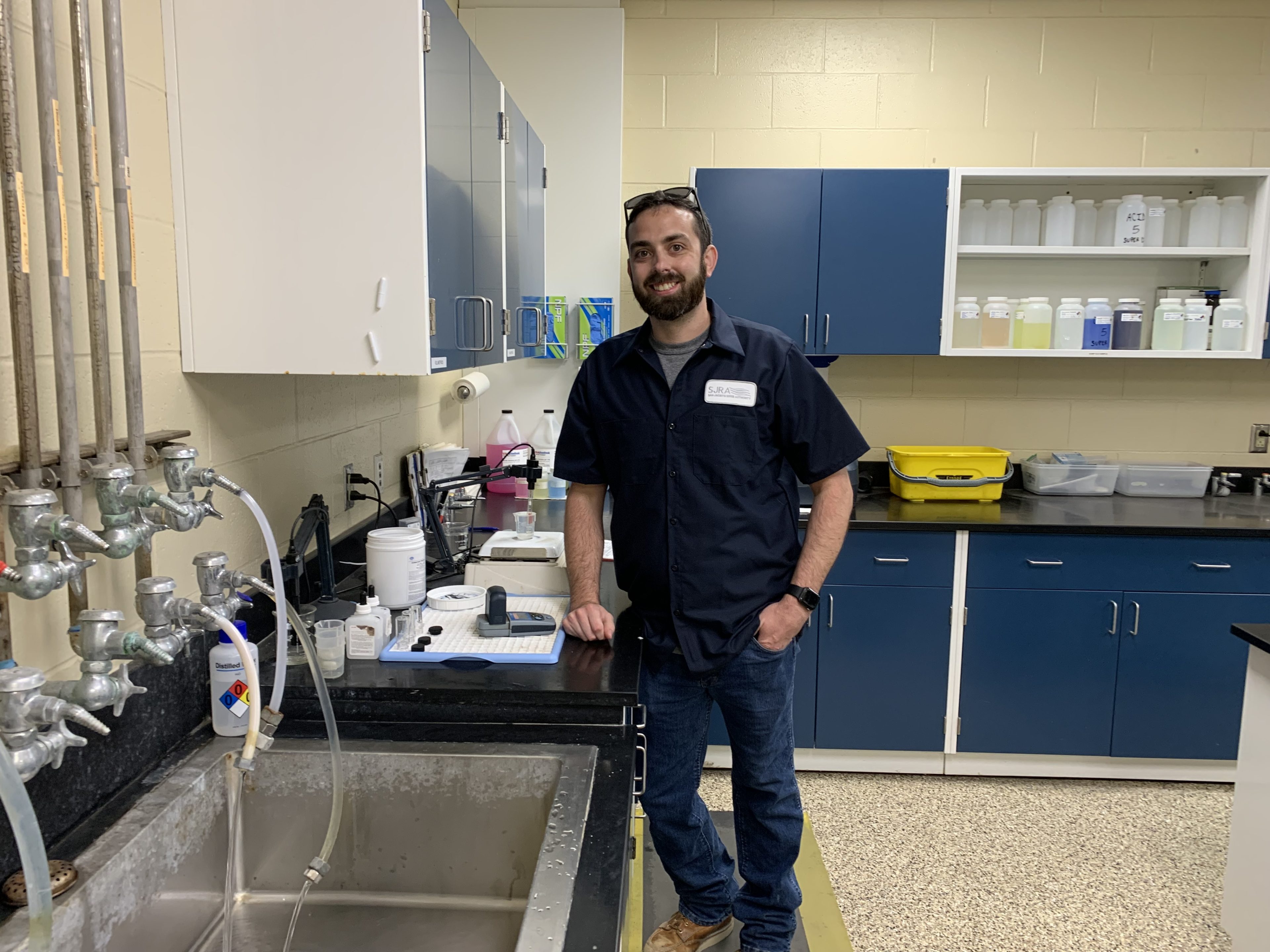 Male in water quality lab in SJRA uniform