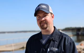 Male in a blue SJRA uniform and SJRA hat